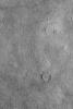 NASA's Mars Global Surveyor shows a cracked plain in western Utopia Planitia on Mars. The three circular crack patterns indicate the location of three buried meteor impact craters.