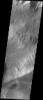 This image released on Oct 7, 2004 from NASA's 2001 Mars Odyssey shows an area on Mars in Candor Chasma. A landslide can be seen on the top slopes. The bottom part of the image shows part of layered deposits that can be found in Candor Chasma.
