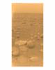 This image was returned on Jan 14, 2005, by the European Space Agency's Huygens probe during its successful descent to land on Titan. This colored view, following processing to add reflection spectra data, gives a better indication of the actual color.