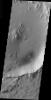 This image from NASA's Mars Odyssey shows a landslide located inside an impact crater in the Elysium region of Mars. The unnamed crater is located at the margin of the volcanic flows from the Elysium Mons complex.
