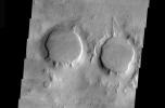 This image is part of THEMIS art month, taken by NASA's Mars Odyssey featuring a portion of Mars' landscape looking like a pair of eyes.