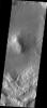 This image taken by NASA's Mars Odyssey shows Deuteronlius Mensae on Mars which contains a central peak in the middle of an older, flat-floored crater, infilled by sediment.