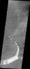 This image taken by NASA's Mars Odyssey shows part of the caldera at the summit of Olympus Mons, a huge volcano on Mars. The arcuate (curved) fractures seen on the right side of the caldera floor were likely formed when later eruptions occurred.