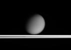 Saturn's hazy moon Titan appears to drift above Saturn's ringplane in this view taken only a tenth of a degree above the rings. This image was taken in visible light with NASA's Cassini spacecraft's narrow-angle camera on March 25, 2005.