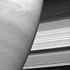 Turbulent swirls churn in Saturn's atmosphere while the planet's rings form a dazzling backdrop. The rings' complex structure is clearly evident in this view captured by NASA's Cassini spacecraft.
