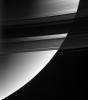 This magnificent view from NASA's Cassini spacecraft looks down upon, and partially through, Saturn's rings from their unlit side. The densest part of the rings occults the bright globe of Saturn.