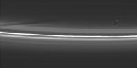 Prometheus poses here with its latest creation: a dark, diagonal gore in the tenuous material interior to Saturn's F ring. This image was taken in visible light with NASA's Cassini spacecraft's narrow-angle camera on Aug. 20, 2005.