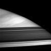 A great storm swims in the cloud lanes of Saturn's high northern latitudes. Dark bands across the bottom of this view from NASA's Cassini spacecraft are shadows cast by the partly opaque rings.