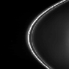 This frame from a movie sequence from NASA's Cassini spacecraft shows dark drapes in the inner strands of Saturn's F ring caused by the gravitational influence of the shepherd moon Prometheus (102 kilometers, or 63 miles across).