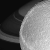 Zooming in closer and closer, this frame from a movie chronicles NASA's Cassini spacecraft targeted flyby of Dione, with Saturn and its lovely rings forming a dramatic backdrop.