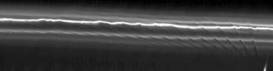 This mosaic of 15 NASA Cassini images of Saturn's F ring shows how the moon Prometheus creates a gore in the ring once every 14.7 hours, as it approaches and recedes from the F ring on its eccentric orbit.