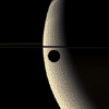 The slim crescent of the moon Rhea glides silently onto the featureless, golden face of Saturn in this mesmerizing color movie. Images were acquired by NASA's Cassini spacecraft's wide-angle camera, at a distance close to 221,000 kilometers from Rhea.