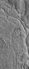 NASA's Mars Global Surveyor shows ridges exposed by erosion in the Aeolis region of Mars. The curved and crisscrossing ridges were once channels in a fan of sediment deposited in the Aeolis lowlands.