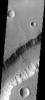 Part of the western wall of Shalbatana Vallis on Mars has collapsed and formed a landslide as seen by NASA's 2001 Mars Odyssey.