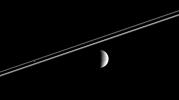 Distant Rhea (right) poses here for NASA's Cassini spacecraft, as Pandora hovers against Saturn's dark shadow on the rings.