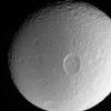 This dramatic close-up from NASA's Cassini spacecraft of Saturn's moon Tethys shows the large crater Penelope lying near center, overprinted by many smaller, younger impact sites.