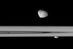 Saturn's moons Janus and Prometheus look close enough to touch in this stunningly detailed view in this image taken by NASA's Cassini spacecraft.