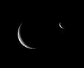 Rhea and Enceladus shared the sky just before the smaller moon passed behind its larger, cratered sibling.This image is part of a 'mutual event' series in which one moon passes close to or in front of another