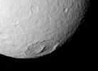 NASA's Cassini spacecraft looks into the wide crater Melanthius in this view of the southern terrain on Saturn's moon Tethys. The crater possesses a prominent cluster of peaks in its center which are relics of its formation.