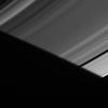 As the particles comprising Saturn's A ring slip into the planet's shadow, they find themselves briefly in the penumbra of Saturn's shadow in this image from NASA's Cassini spacecraft.