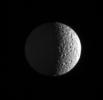 NASA's Cassini spacecraft zooms in on Mimas, pitted by craters and slightly out-of-round. Cassini images taken during a flyby of Mimas in August 2005 showed the moon's battered surface up close.