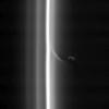 This view from NASA's Cassini spacecraft shows Saturn's shepherd moon Prometheus with a streamer it has created in the inner edge of the F ring. Prometheus comes close to the inner edge of the ring once per orbit, perturbing the ring particles there.