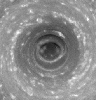 NASA's Cassini spacecraft stares deep into the swirling hurricane-like vortex at Saturn's south pole, where the vertical structure of the clouds is highlighted by shadows.