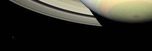 NASA's Cassini spacecraft takes in a sweeping view of Saturn's south polar region as the planet's shadow masks the rings and bright, icy Mimas looks on from left.
