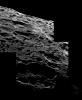 NASA's Cassini soars above the many pits and basins in the rolling landscape of Saturn's moon Iapetus. This mosaic view looks out onto an area close to the northern bright/dark boundary, but still within the dark region, Cassini Regio.