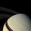 The ringed planet sits in repose, the center of its own macrocosm of many rings and moons and one artificial NASA satellite named Cassini. Mimas (397 kilometers, or 247 miles across) is visible at upper left.