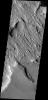 This image has a cracked plateau of material next to a low region of interconnected small ridges. This region is located at the northwestern end of Gordii Dorsum on Mars as seen by NASA's 2001 Mars Odyssey spacecraft.