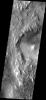 The erosion of the western rim of Hellas Basin on Mars has exposed a surface composed of layered material as seen by NASA's 2001 Mars Odyssey.