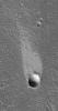 NASA's Mars Global Surveyor shows a light-toned wind streak created in the lee, downwind side, of an impact crater in the Cyane Fossae region of Mars.