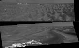 NASA's Mars Global Surveyor shows the outcrop-rimmed 'Beagle Crater' appearing on the horizon as the Mars Exploration Rover Opportunity approached it on June 20, 2006. Blocks of ejecta can be seen around the prominent, raised rim of Beagle crater.