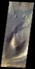 This image from NASA's 2001 Mars Odyssey shows the sand dunes and layered material common on the floor of Valles Marineris.