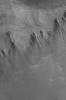 This image from NASA's Mars Global Surveyor shows a group of gullies formed on the equator-facing wall of a north mid-latitude crater. Gullies such as these might have formed from the erosive forces of liquid water.