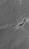 This image from NASA's Mars Global Surveyor shows the inverted, eroded remains of a channel, now standing as a complex ridge that runs across the middle of this scene, in dust-mantled terrain west of Sinus Meridiani, Mars.