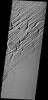 This image shows part of Sacra Sulci, a region of high standing grooves, crosscut by cracks and fractures. Lava flows are present to the south and sand dunes fill the floor of the large cracks on Mars as seen by NASA's Mars Odyssey spacecraft.