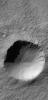 This image from NASA's Mars Global Surveyor shows rocks and gullies are visible in the northern walls of the crater. A small patch of large, windblown ripples cover part of the crater floor.