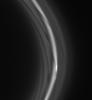 The striated appearance of the F ring is immediately apparent in the region of the ring that trails behind the moon Prometheus as seen by NASA's Cassini spacecraft.