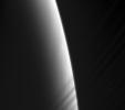 NASA's Cassini spacecraft looks toward daybreak on Saturn through the delicate strands of the C ring. Some structure and contrast is visible in the clouds far below.