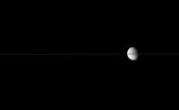 Dione floats in the sea of space, bisected by Saturn's edge-on ringplane. This image was taken in visible light with NASA's Cassini spacecraft's narrow-angle camera on July 2, 2007 at a distance of approximately 2.5 million kilometers from Dione.