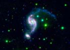 NASA's Galaxy Evolution Explorer and Spitzer Space Telescope combined to show a pair of interacting galaxies might be experiencing the galactic equivalent of a mid-life crisis. 