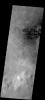 This image from NASA's Mars Odyssey spacecraft shows dark sand dunes and nearby dust devil tracks located on the floor of Green Crater.