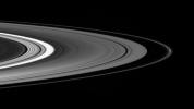 On Oct. 1, 2007, NASA's Cassini spacecraft spies the small moon Atlas, accompanied by bright clumps of material in the F ring, as it gazed down at the unilluminated side of the rings.