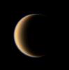 Titan's hazy orange globe hangs before NASA's Cassini spacecraft, partly illuminated -- a world with many mysteries yet to be uncovered.