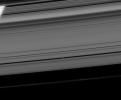 Pan coasts down its private highway within the Encke Gap. The limb of Saturn is seen through the rings at upper left in this image taken by NASA's Cassini spacecraft on Apr. 24, 2008.