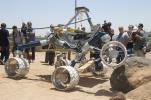 Onlookers watch as Scarecrow, a mobility-testing model for NASA's Mars Science Laboratory, easily conquers boulders in the Mars Yard testing area at NASA's Jet Propulsion Laboratory.