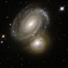 AM 0500-620 consists of a highly symmetric spiral galaxy seen nearly face-on and partially backlit by a background galaxy. This image is part of a large collection of images of merging galaxies taken by NASA's Hubble Space Telescope.