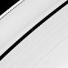 Saucer-shaped Pan glides through the Encke Gap in Saturn's rings in this image captured by NASA's Cassini spacecraft on June 10, 2008.